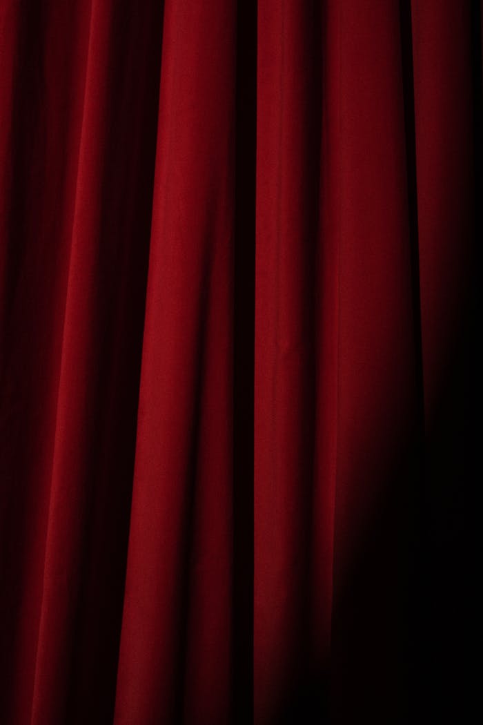 Deep red velvet theater curtain, perfect for presentations or artistic backgrounds.
